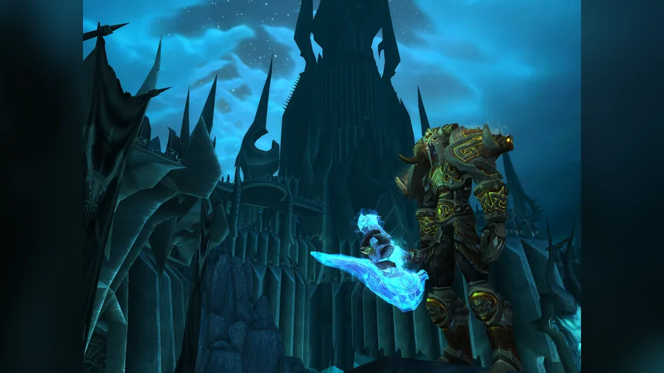 Armored player with an icy weapon before a dark spiked citadel tower.